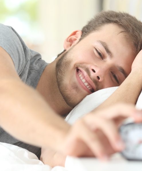 Man waking feeling rested thanks to sleep apnea therapy