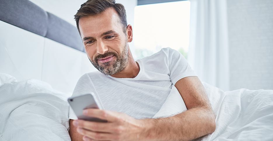 Man using smartphone to contact the Nelson Dental Sleep Medicine team