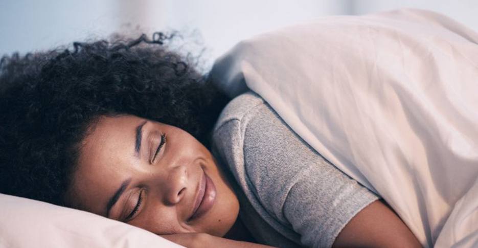 Woman sleeping peacefully in cozy bed