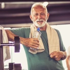 Older man smiling after working out at the gym