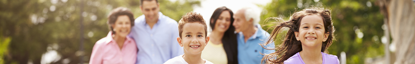 family smiling and running outdoors