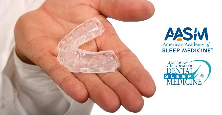 Hand holding a custom sleep apnea oral appliance