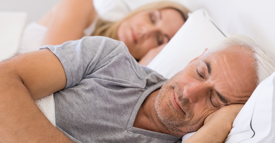 Man sleeping soundly thanks to prosomnus oral appliance sleep apnea treatment