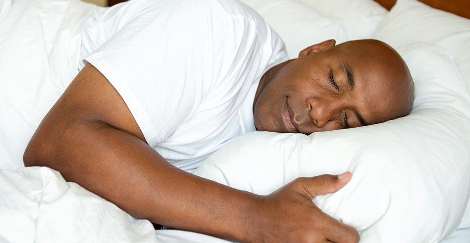 Man sleeping soundly thanks to somnodent avant oral appliance