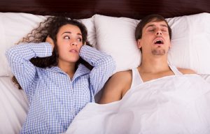woman irritated with partner’s snoring