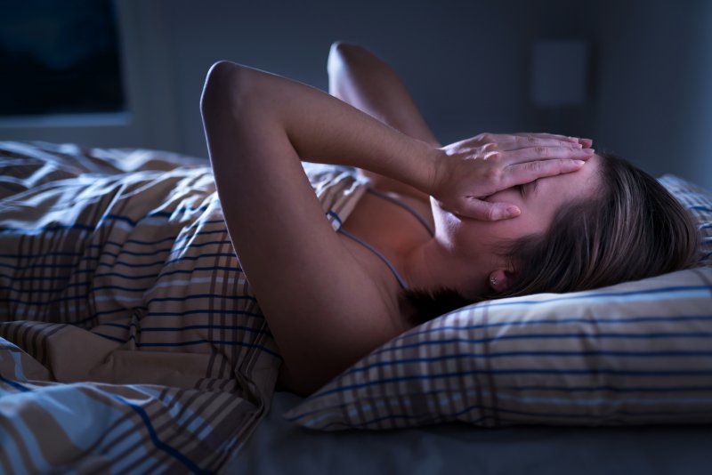 Woman awake in bed due to sleep apnea in Lutz