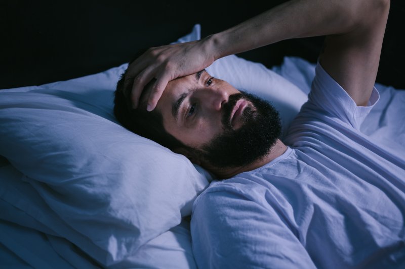 Man lying awake in bed