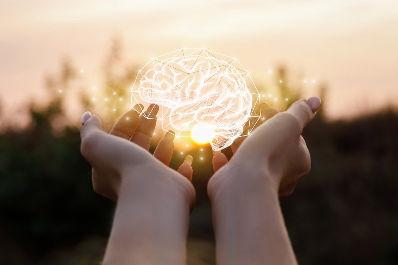 young woman holding brain in her hands