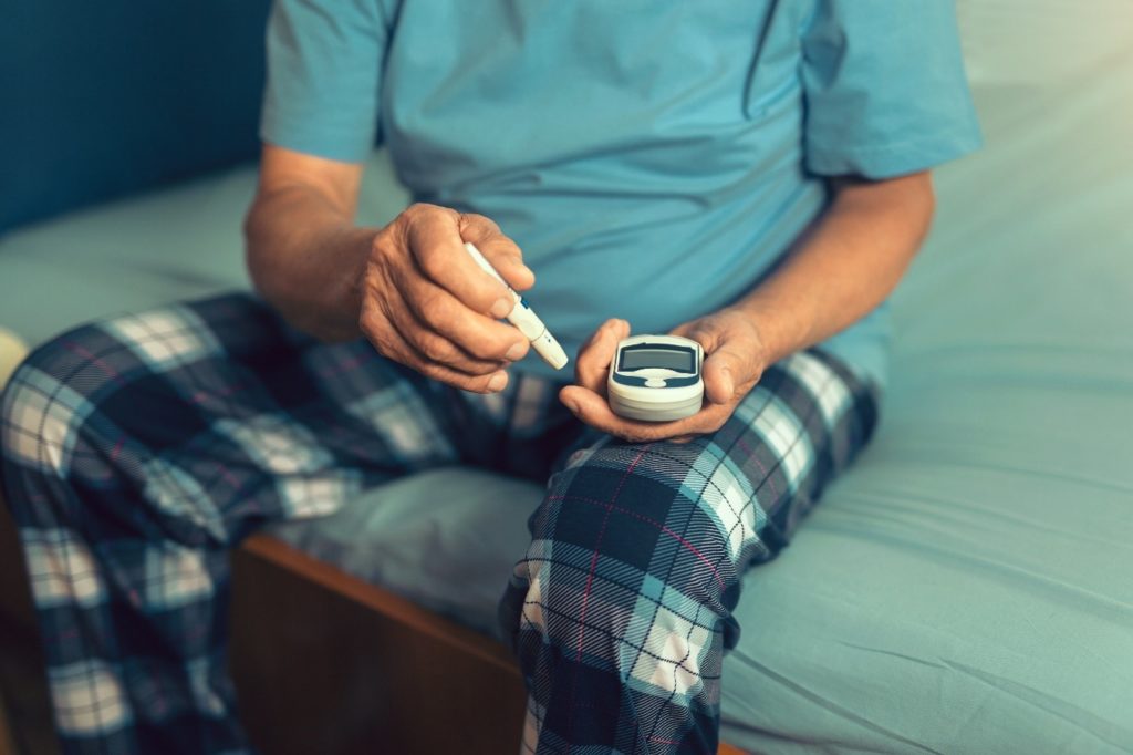 Man checking blood sugar level.