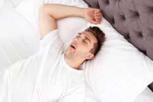 Man snoring due to his sleep apnea.