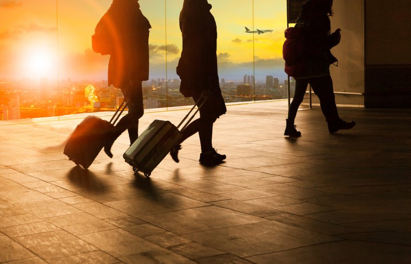 people carrying luggage in an airport