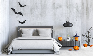 Bed surrounded by a number of Halloween decorations